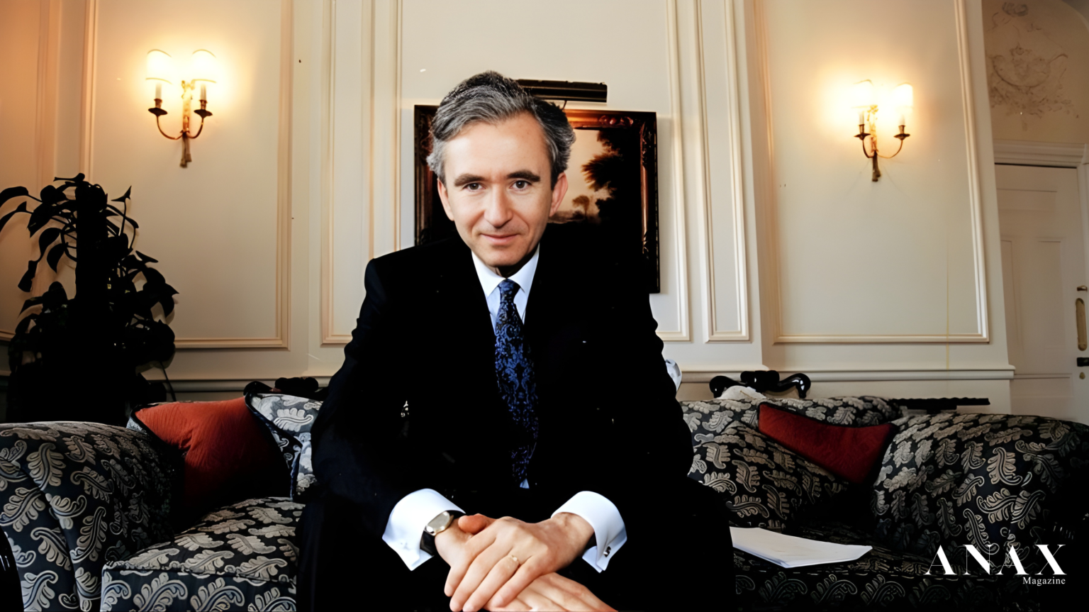 A black and white portrait of Bernard Arnault, looking contemplative, overlaid with a subtle texture of a cashmere fabric.